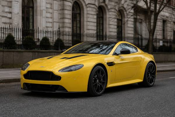 Aston Martin V12 Vantage S specs: 5.9L naturally aspirated V12, 565 hp, 620 Nm, Sportshift III or manual, 3.9-sec 0–62 mph, and 205 mph top speed.